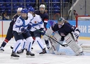 SOCHI, RUSSIA - FEBRUARY 8: USA's Jessie Vetter #31 gets into position while Finland's Minnamari Tumominen #15 looks for a scoring chance during women's preliminary round action at the Sochi 2014 Olympic Winter Games. (Photo by Jeff Vinnick/HHOF-IIHF Images)

