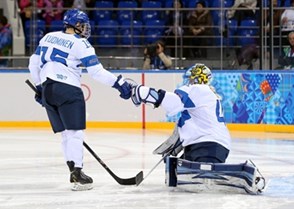 SOCHI, RUSSIA - FEBRUARY 10: Finland's Minttu Tumominen #15 fist-pump goaltender Noora Raty #41 prior to their game opposing Canada during women's preliminary round action at the Sochi 2014 Olympic Winter Games. (Photo by Andre Ringuette/HHOF-IIHF Images)

