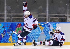 SOCHI, RUSSIA - FEBRUARY 16: USA'S Phil Kessel #81 celebrates after a first period goal as Joe Pavelski #8 crashes into the end boards during men's preliminary round action against Slovenia at the Sochi 2014 Olympic Winter Games. (Photo by Jeff Vinnick/HHOF-IIHF Images)

