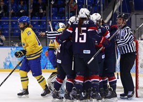 SOCHI, RUSSIA - FEBRUARY 17: Sweden's Emilia Andersson #10 skates away as USA players celebrate after a first period goal during women's semifinal action at the Sochi 2014 Olympic Winter Games. (Photo by Jeff Vinnick/HHOF-IIHF Images)

